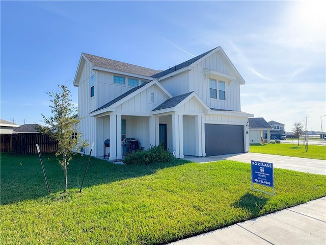 view of front of house featuring a front yard and a garage