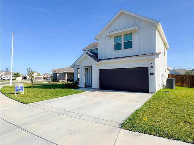 view of front of house featuring central AC unit, a front lawn, and a garage