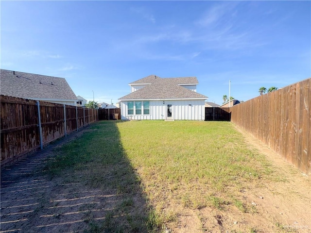 rear view of house with a yard