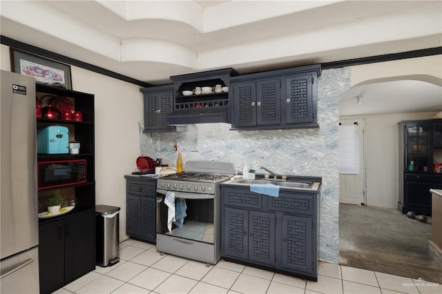 18315 Washington Palm Dr, Penitas, TX 78576 - kitchen with gas stove, a sink, white refrigerator, black microwave, and under cabinet range hood