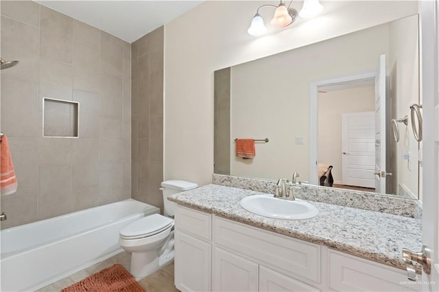 full bathroom featuring tile patterned floors, toilet, an inviting chandelier, vanity, and tiled shower / bath combo