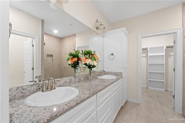 bathroom with tile patterned floors, vanity, and an enclosed shower