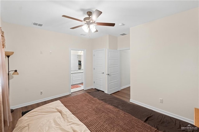 bedroom featuring dark wood-type flooring, ceiling fan, and ensuite bathroom