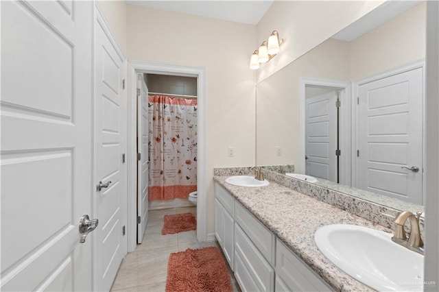 bathroom featuring tile patterned flooring, vanity, and toilet