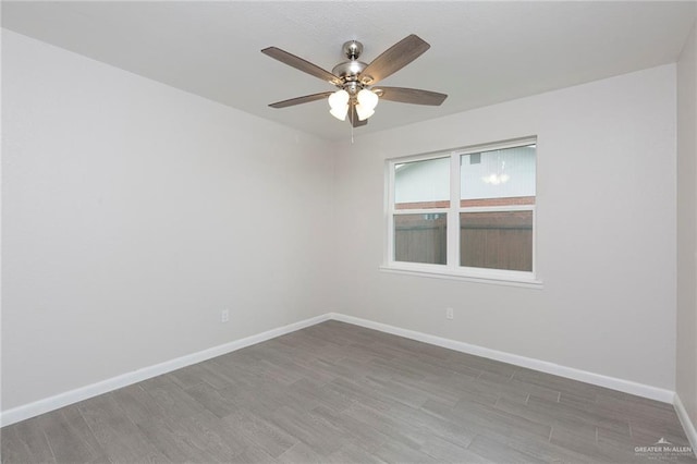 spare room featuring hardwood / wood-style floors and ceiling fan