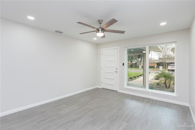 unfurnished room with ceiling fan and light hardwood / wood-style floors