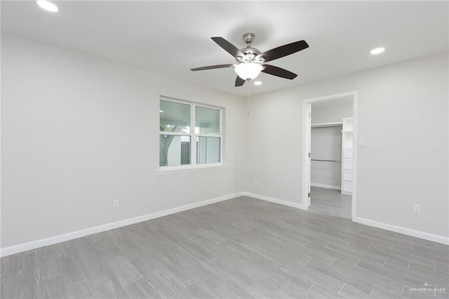 unfurnished room with light hardwood / wood-style flooring and ceiling fan