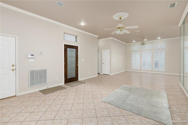 tiled entrance foyer with ceiling fan and ornamental molding