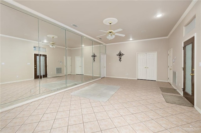 unfurnished room with crown molding, ceiling fan, and light tile patterned floors