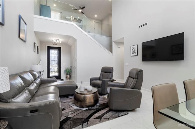 2215 Corales St, Mission, TX 78573 - living area with a high ceiling, marble look tile flooring, and recessed lighting