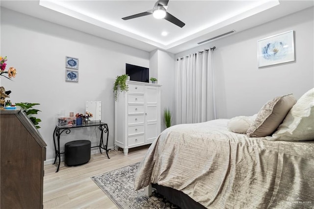 2215 Corales St, Mission, TX 78573 - bedroom featuring a raised ceiling, wood finished floors, and ceiling fan