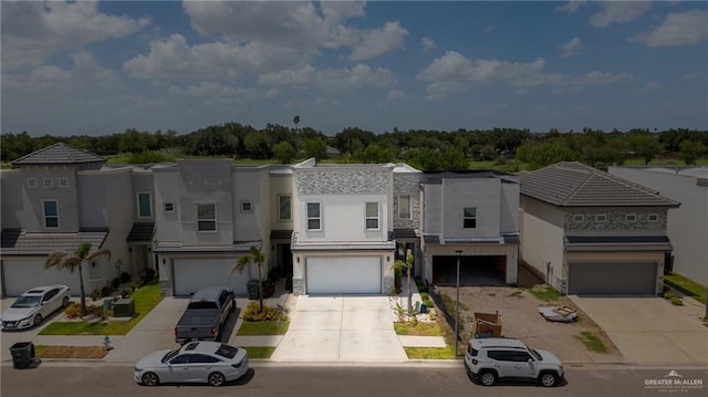 2215 Corales St, Mission, TX 78573 - view of property with concrete driveway, a garage, and stucco siding