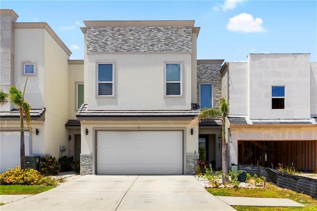 2215 Corales St, Mission, TX 78573 - multi unit property with a standing seam roof, stone siding, an attached garage, concrete driveway, and stucco siding