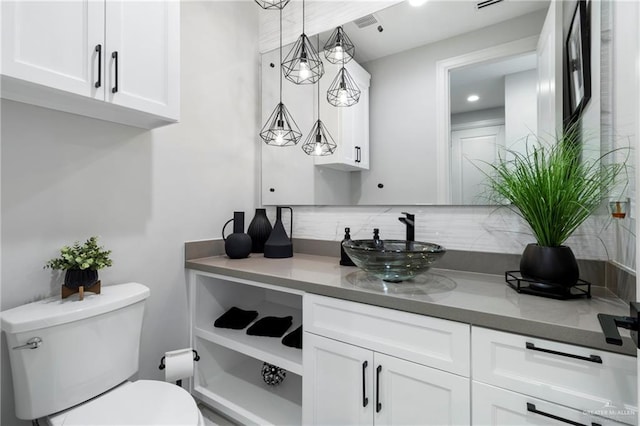 2215 Corales St, Mission, TX 78573 - bathroom featuring decorative backsplash and vanity