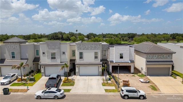 2215 Corales St, Mission, TX 78573 - view of property featuring concrete driveway, an attached garage, and stucco siding