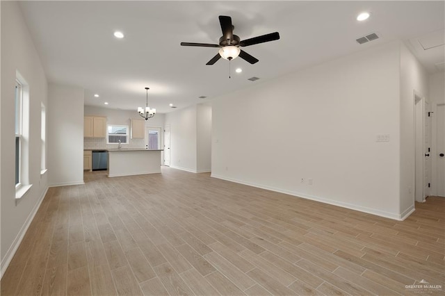 unfurnished living room featuring recessed lighting, visible vents, light wood-style flooring, and ceiling fan with notable chandelier