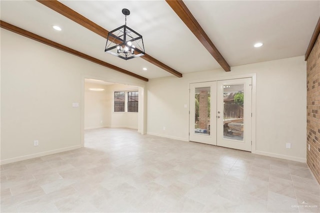 unfurnished living room featuring a chandelier, brick wall, french doors, and vaulted ceiling with beams