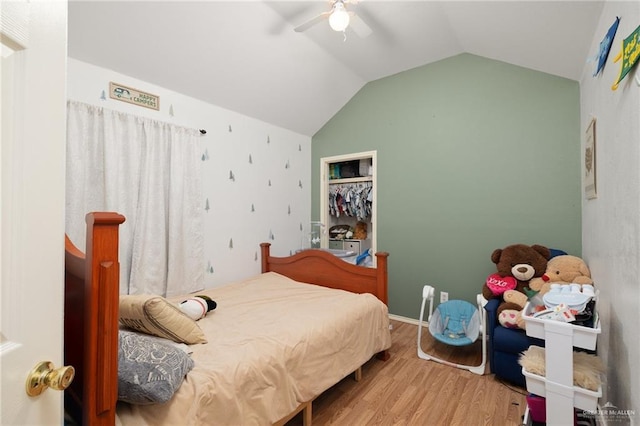 bedroom with a ceiling fan, lofted ceiling, and wood finished floors