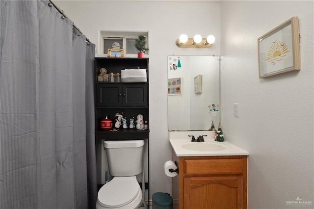 bathroom with toilet, a shower with shower curtain, and vanity