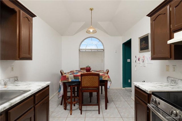 kitchen with vaulted ceiling, dark brown cabinets, and decorative light fixtures