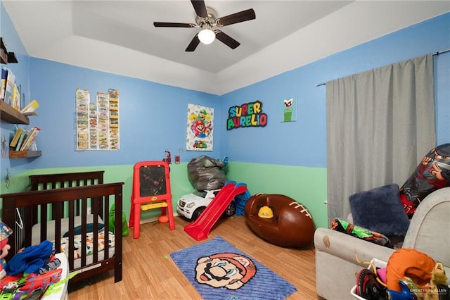 bedroom with wood finished floors and a ceiling fan