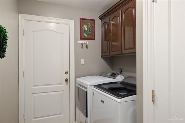 clothes washing area with cabinet space and washing machine and clothes dryer