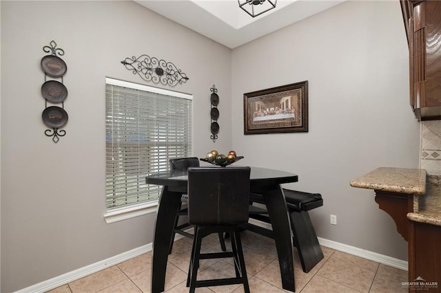 dining room with light tile patterned flooring and baseboards