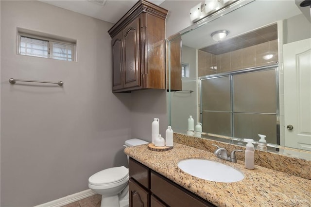 bathroom with tile patterned floors, toilet, a shower stall, baseboards, and vanity