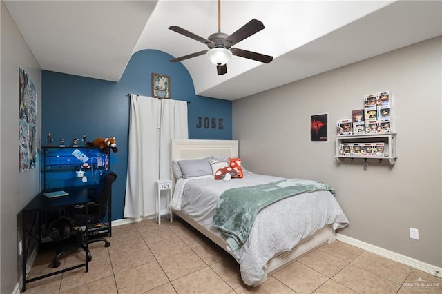 bedroom featuring tile patterned floors, ceiling fan, baseboards, and vaulted ceiling