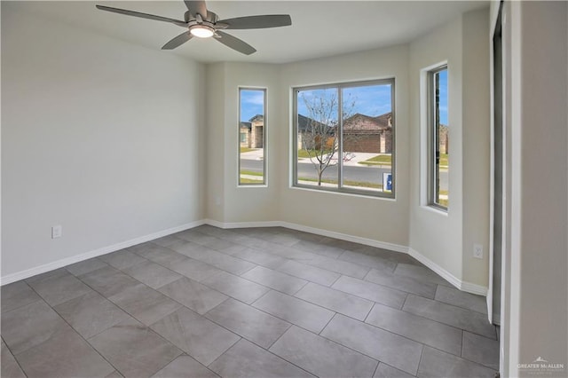 tiled empty room with ceiling fan