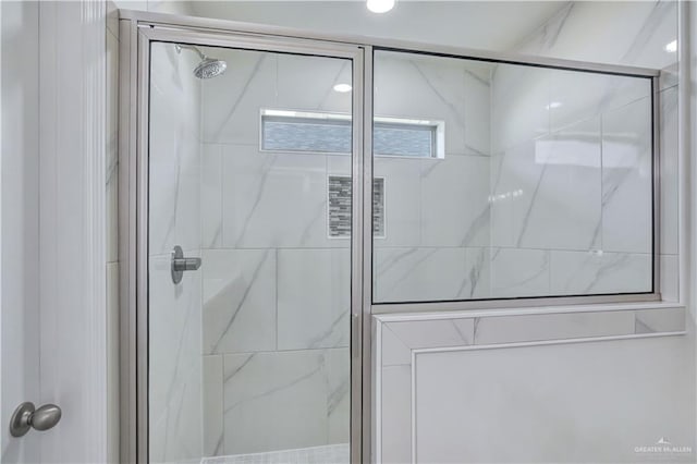 bathroom featuring a shower with door