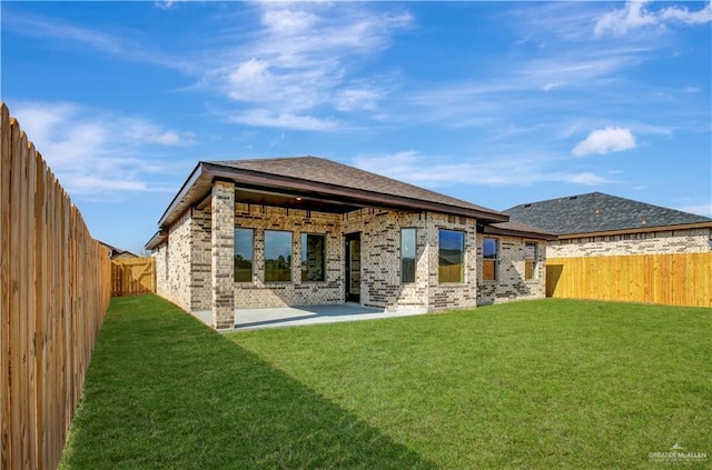 back of house featuring a lawn and a patio