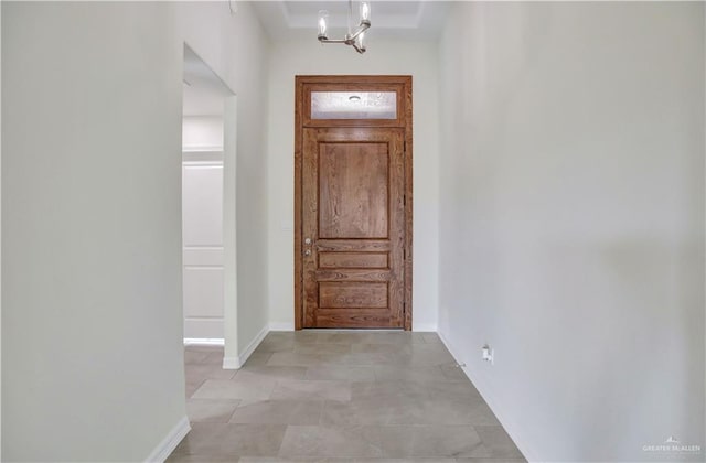 foyer entrance featuring a notable chandelier