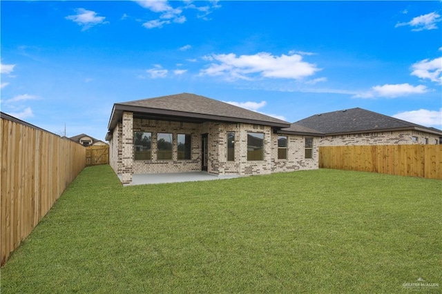 rear view of house with a patio area and a yard