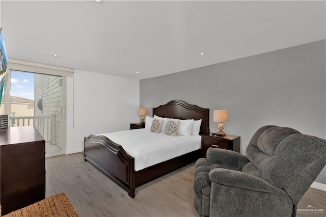 bedroom with baseboards, access to outside, wood finished floors, and recessed lighting