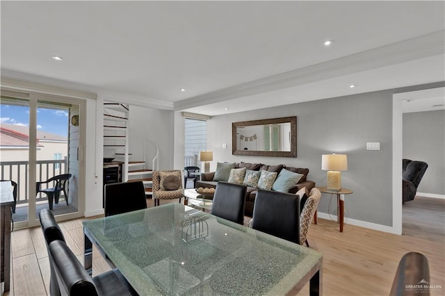 dining area featuring ornamental molding, recessed lighting, light wood-style floors, and stairway