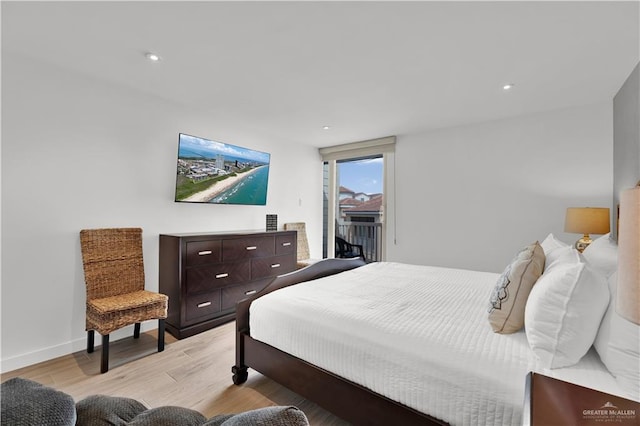 bedroom featuring light wood-type flooring, recessed lighting, and access to exterior