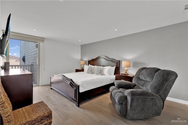 bedroom featuring light wood finished floors, baseboards, access to outside, visible vents, and recessed lighting