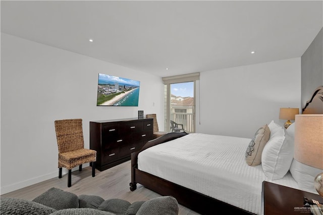 bedroom with light wood finished floors, baseboards, recessed lighting, and access to exterior