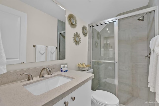 full bath with a shower stall, toilet, and vanity