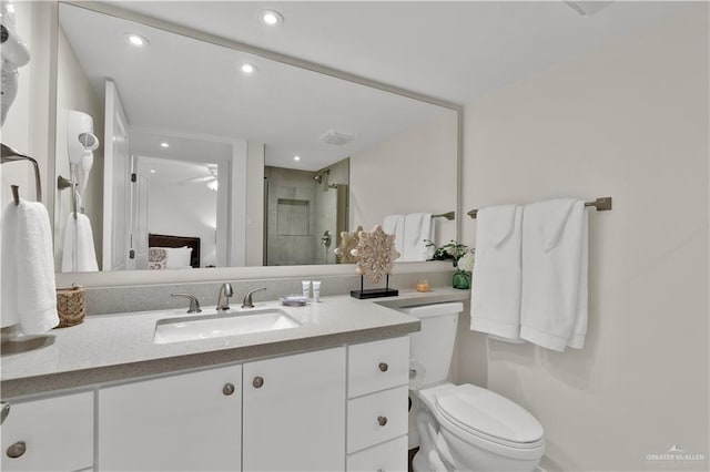 full bathroom with a ceiling fan, a stall shower, vanity, toilet, and recessed lighting