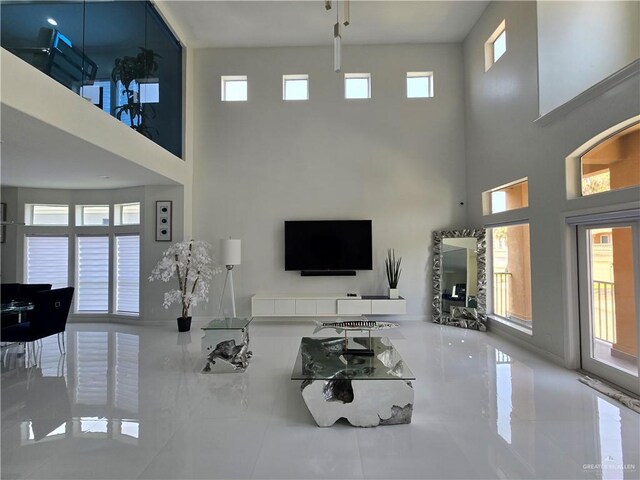 6503 Fountain Way S, Padre Island, TX 78597 - living room featuring a towering ceiling and tile patterned floors