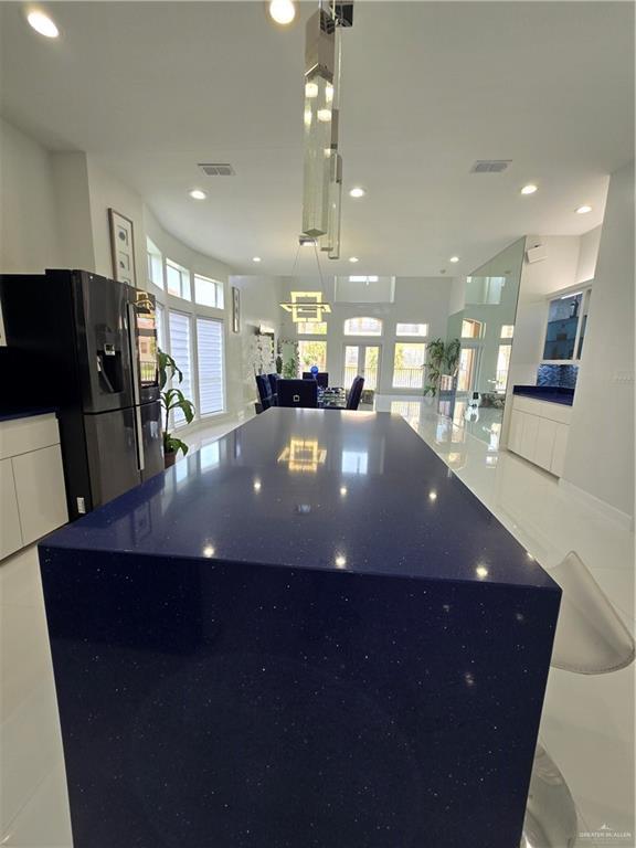 6503 Fountain Way S, Padre Island, TX 78597 - kitchen featuring open floor plan, fridge with ice dispenser, white cabinets, recessed lighting, and modern cabinets