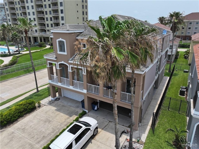 6503 Fountain Way S, Padre Island, TX 78597 - view of building exterior with a garage and driveway