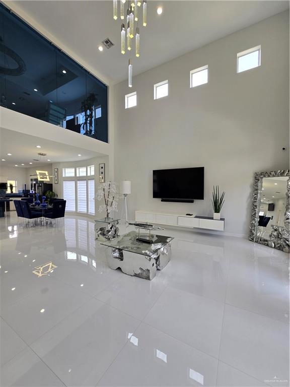 6503 Fountain Way S, Padre Island, TX 78597 - tiled living area with a towering ceiling, plenty of natural light, and recessed lighting