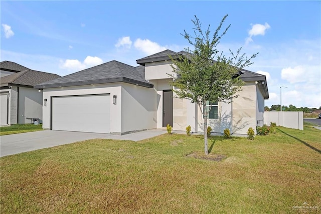 view of front of property featuring a front lawn and a garage