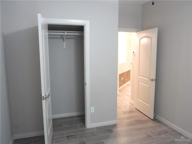 502 Castillos Y Diamantes St, Mission, TX 78572 - unfurnished bedroom with wood tiled floors, a closet, and baseboards