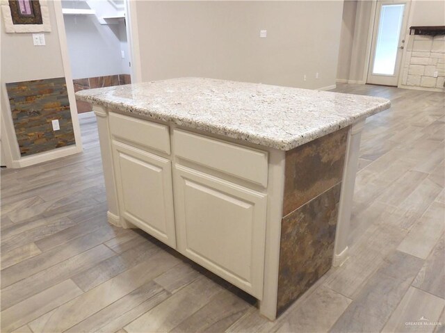 502 Castillos Y Diamantes St, Mission, TX 78572 - kitchen with light wood-style floors, a center island, and light stone counters