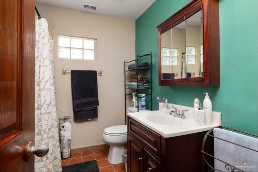 bathroom with tile patterned floors, vanity, and toilet