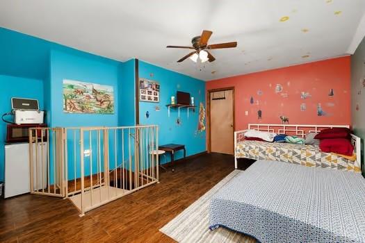 bedroom featuring ceiling fan and dark hardwood / wood-style flooring